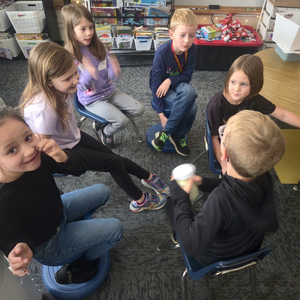 students shaking jars to make butter