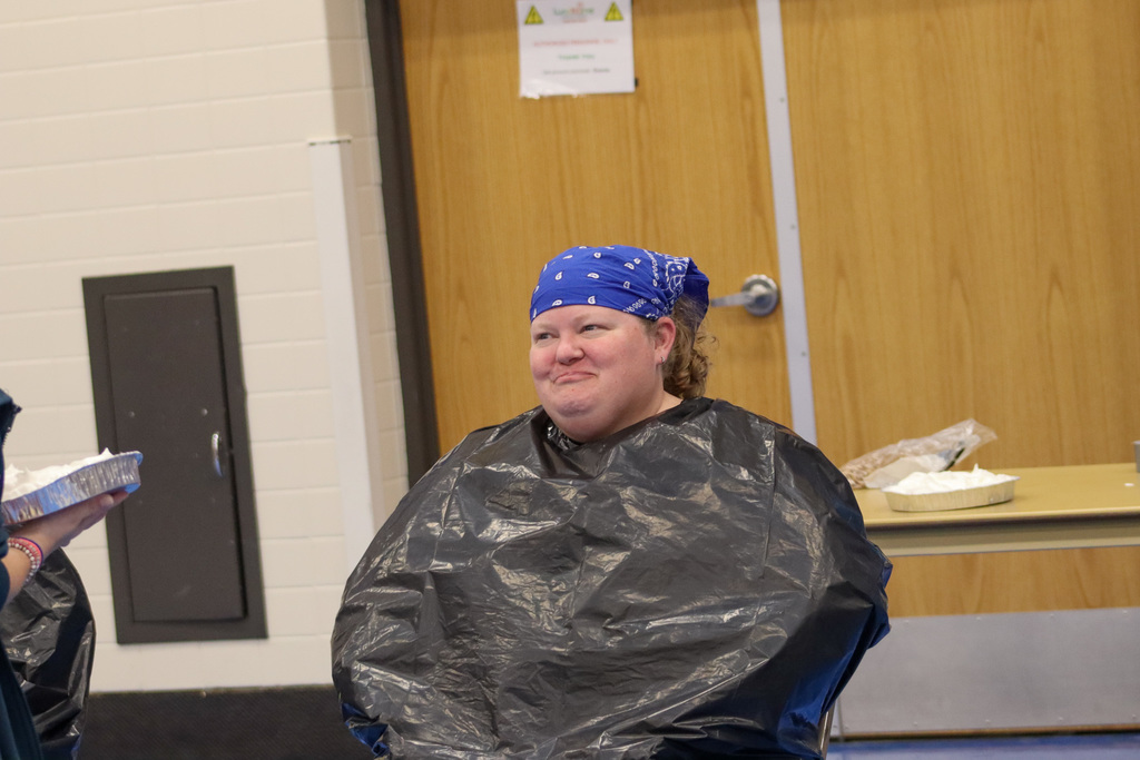 A student about to throw a pie in the face of Ms. Leitheiser at SMS