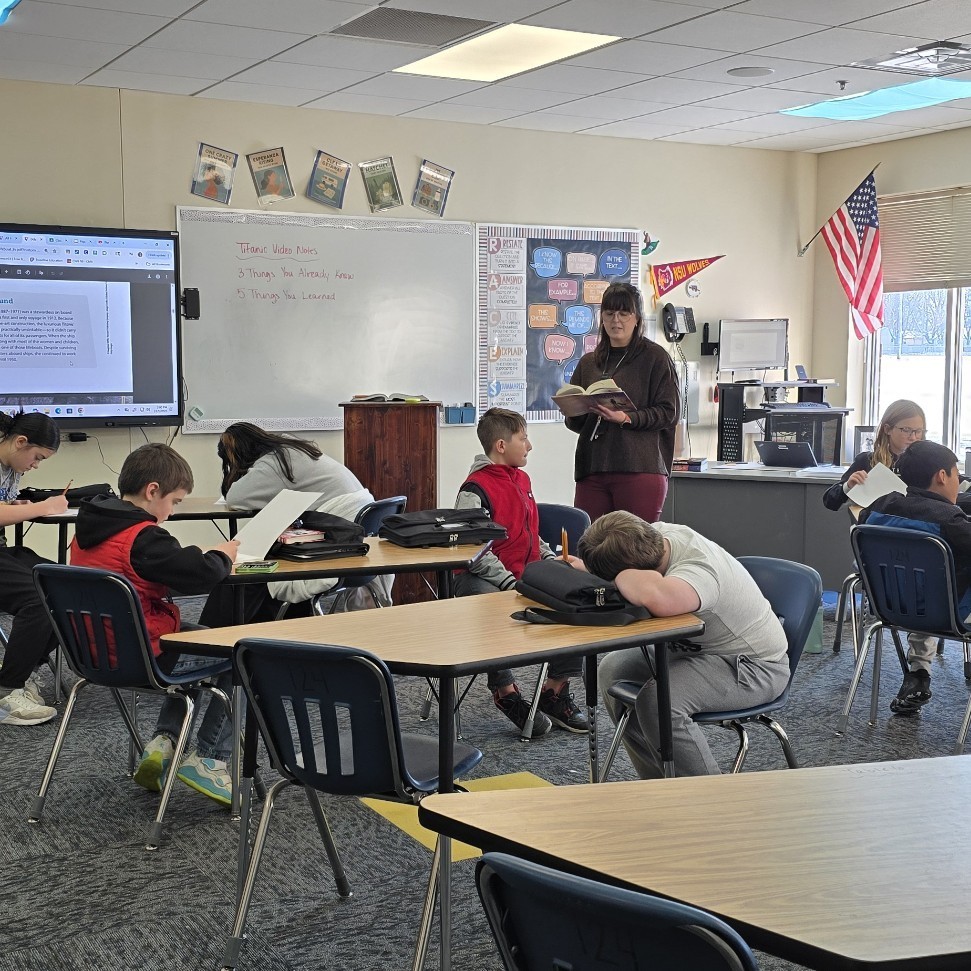 Students relax with a read-aloud.