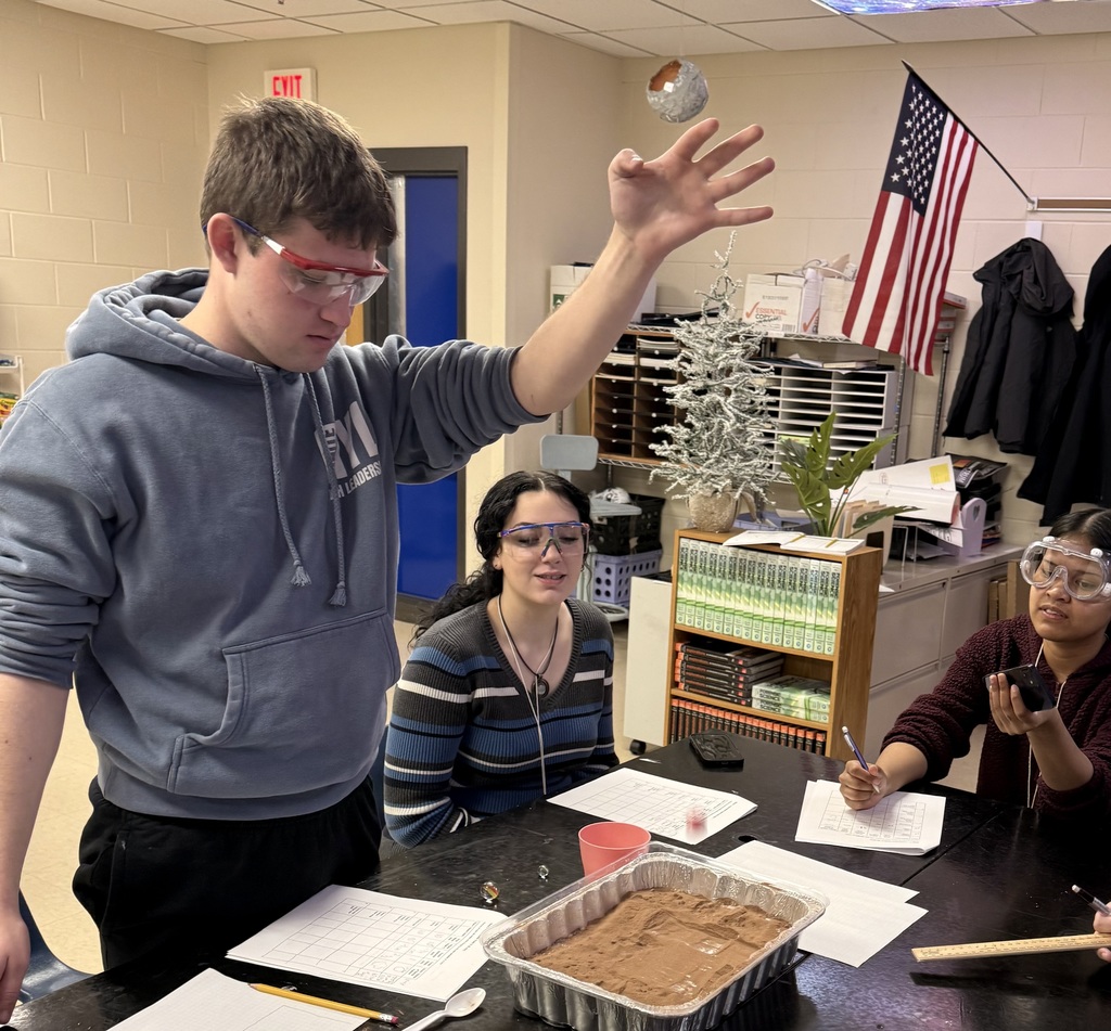 Setting up a vertical drop test to study how height impacts crater formation.