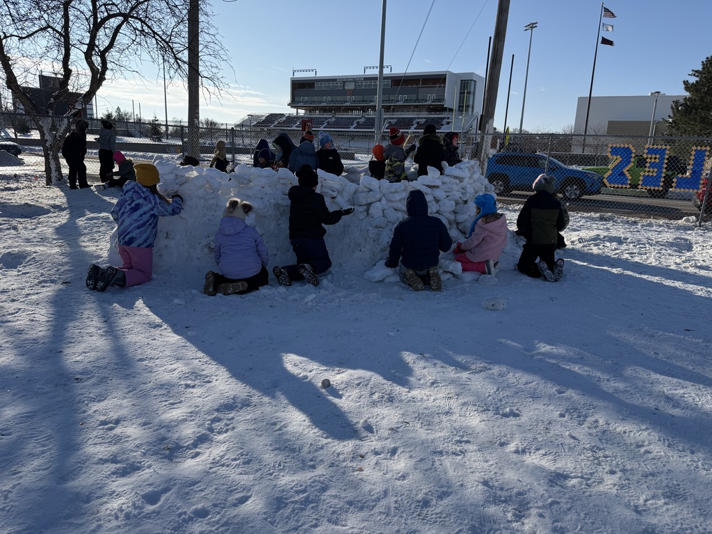May Overby students building an igloo at recess