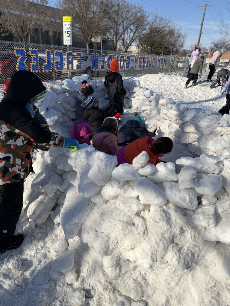 May Overby students building an igloo at recess