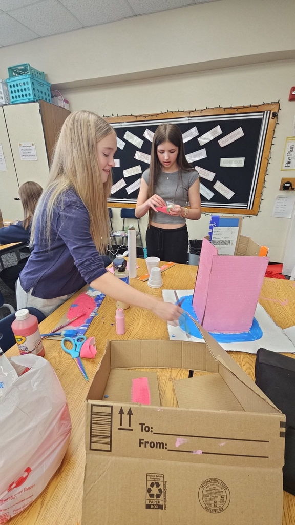 Students in Ms. Gross’ class are wrapping up their Descriptive Writing Unit with a creative culminating activity! Working in pairs, students became real estate agents for Reindeer Realty, writing vivid descriptive paragraphs to “sell” their gingerbread houses.  To bring their writing to life, students designed and built their gingerbread houses using cardboard and other materials, focusing on details that matched their descriptions.  On Friday, 6th and 7th grade students will tour the neighborhood and “purchase” the houses that best match the written descriptions. This engaging project combines creativity, collaboration, and strong writing skills—and it’s been a huge hit! 🎄🏠✏️