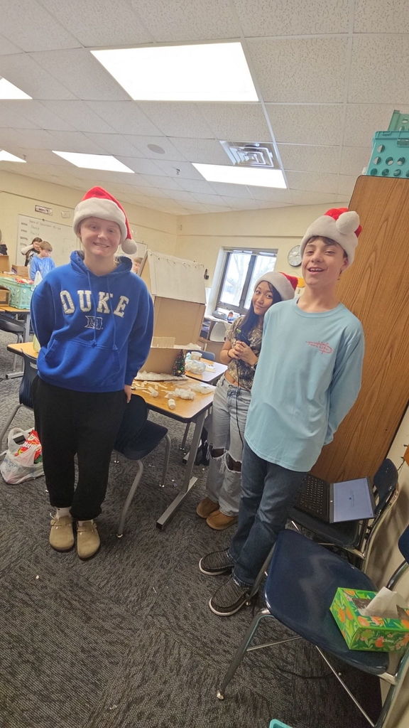 Students in Ms. Gross’ class are wrapping up their Descriptive Writing Unit with a creative culminating activity! Working in pairs, students became real estate agents for Reindeer Realty, writing vivid descriptive paragraphs to “sell” their gingerbread houses.  To bring their writing to life, students designed and built their gingerbread houses using cardboard and other materials, focusing on details that matched their descriptions.  On Friday, 6th and 7th grade students will tour the neighborhood and “purchase” the houses that best match the written descriptions. This engaging project combines creativity, collaboration, and strong writing skills—and it’s been a huge hit! 🎄🏠✏️