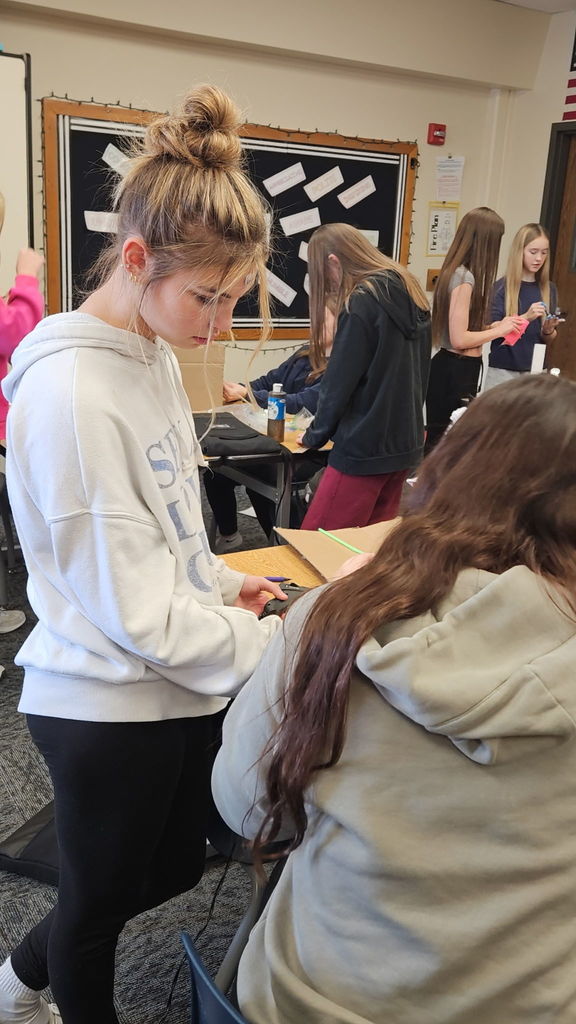 Students in Ms. Gross’ class are wrapping up their Descriptive Writing Unit with a creative culminating activity! Working in pairs, students became real estate agents for Reindeer Realty, writing vivid descriptive paragraphs to “sell” their gingerbread houses.  To bring their writing to life, students designed and built their gingerbread houses using cardboard and other materials, focusing on details that matched their descriptions.  On Friday, 6th and 7th grade students will tour the neighborhood and “purchase” the houses that best match the written descriptions. This engaging project combines creativity, collaboration, and strong writing skills—and it’s been a huge hit! 🎄🏠✏️