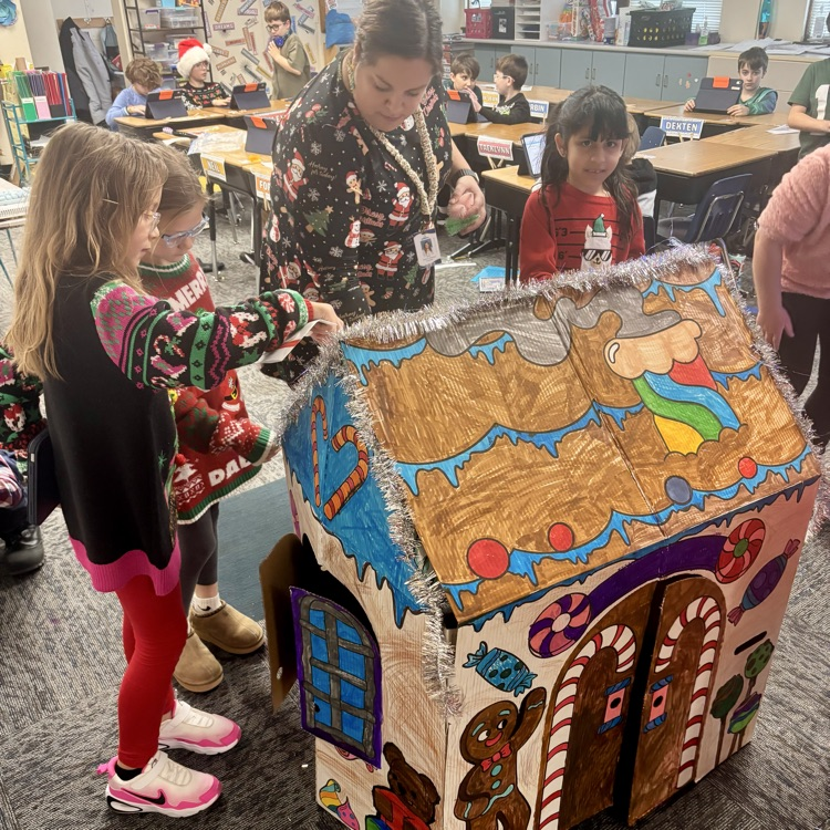 Students work together to create their gingerbread houses.