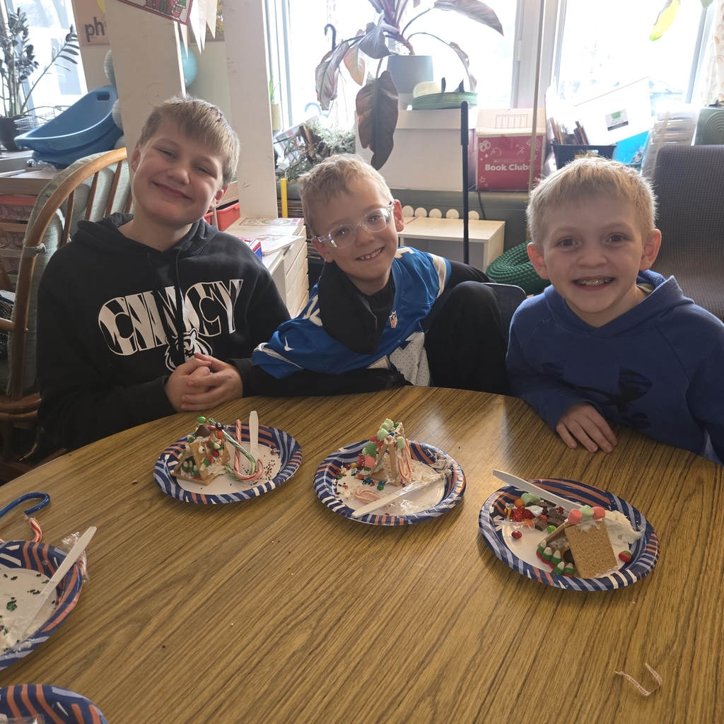 First and fifth grade students with their gingerbread houses