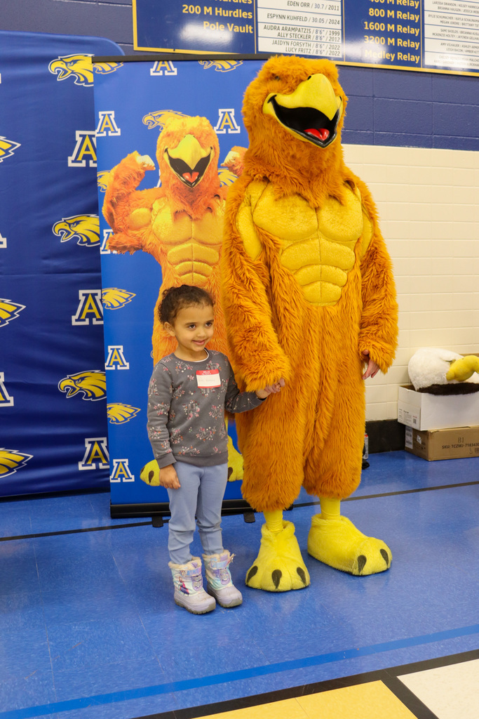 Student taking a picture with the Golden Eagle at Kindergarten Registration Day