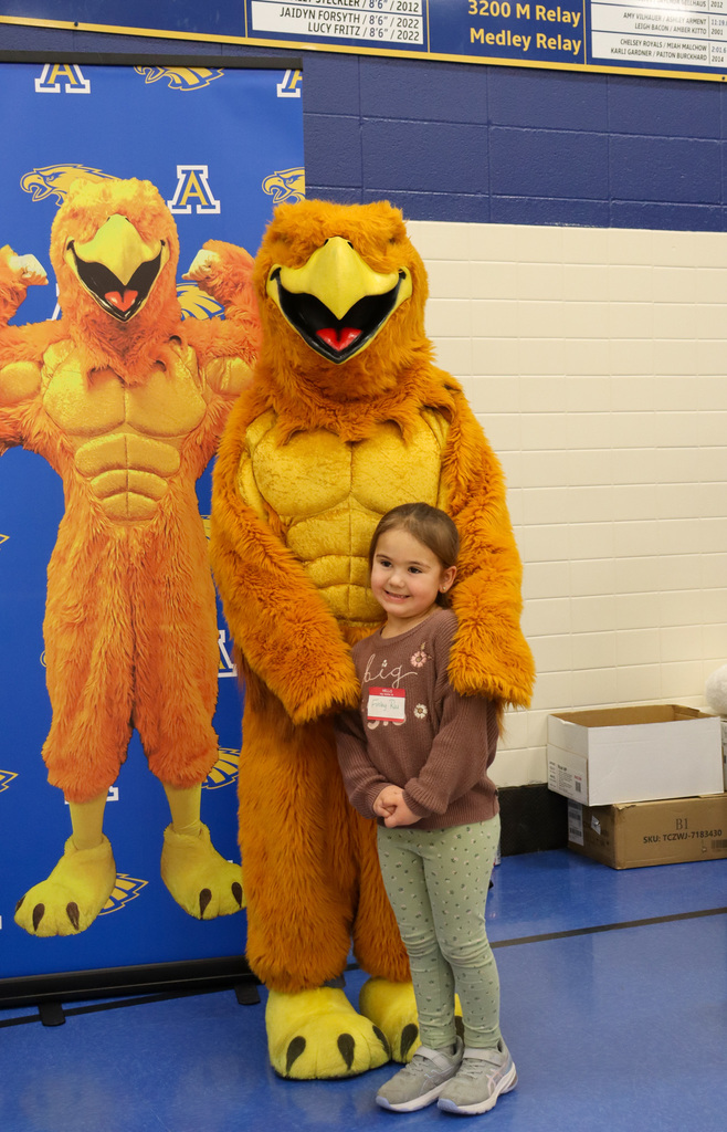Student taking a picture with the Golden Eagle at Kindergarten Registration Day