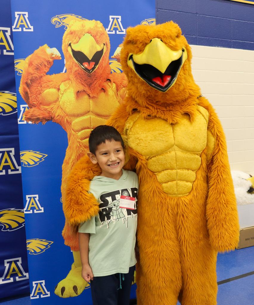 Student taking a picture with the Golden Eagle at Kindergarten Registration Day