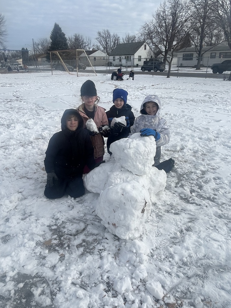 Students building a snowman