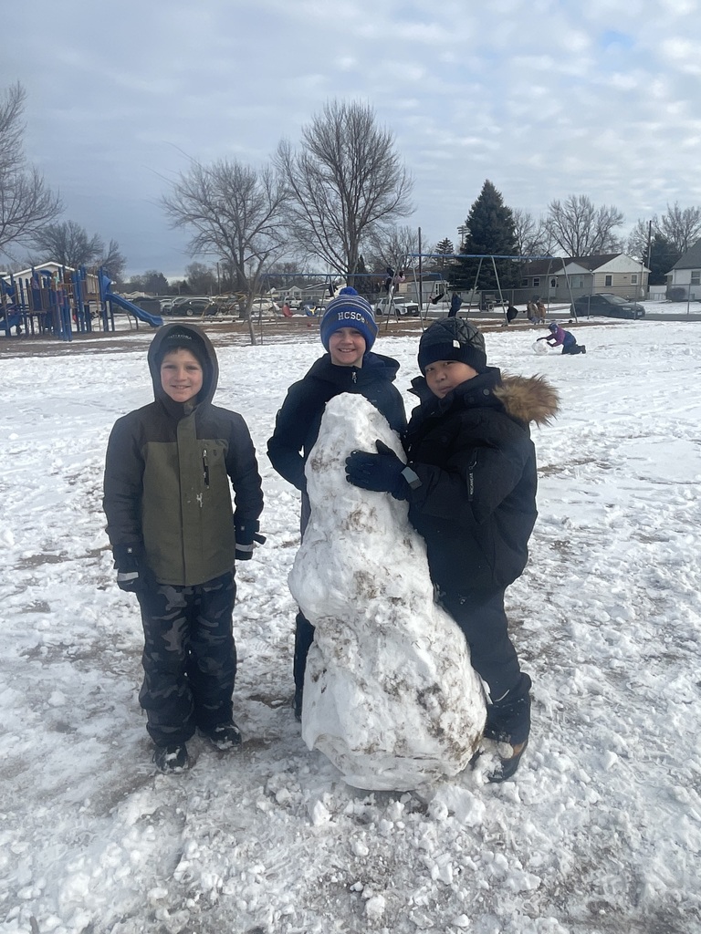Students building a snowman