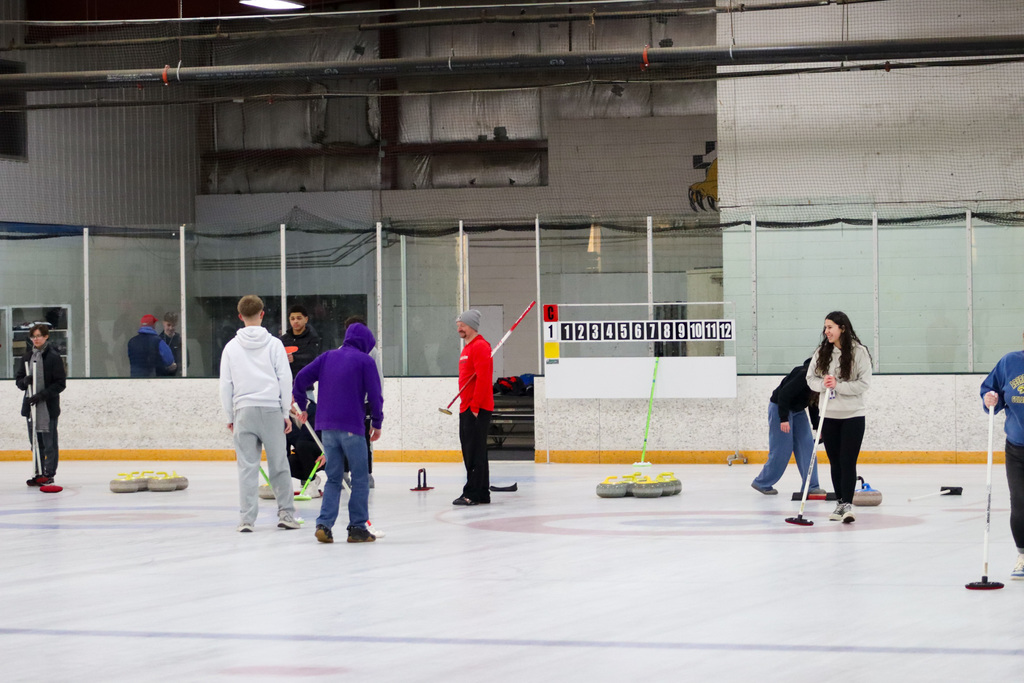 CHS students trying curling with Aberdeen Curling Club members at Odde Ice Arena