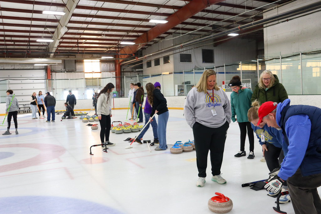 CHS students and teachers trying curling with Aberdeen Curling Club members at Odde Ice Arena