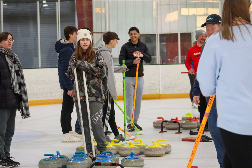 CHS students trying curling with Aberdeen Curling Club members at Odde Ice Arena