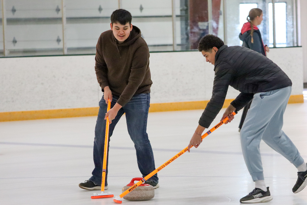 CHS students trying curling with Aberdeen Curling Club members at Odde Ice Arena