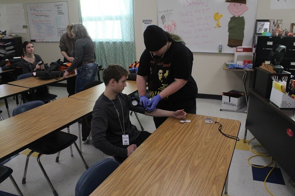 ATEC EMT students practicing vitals on other students