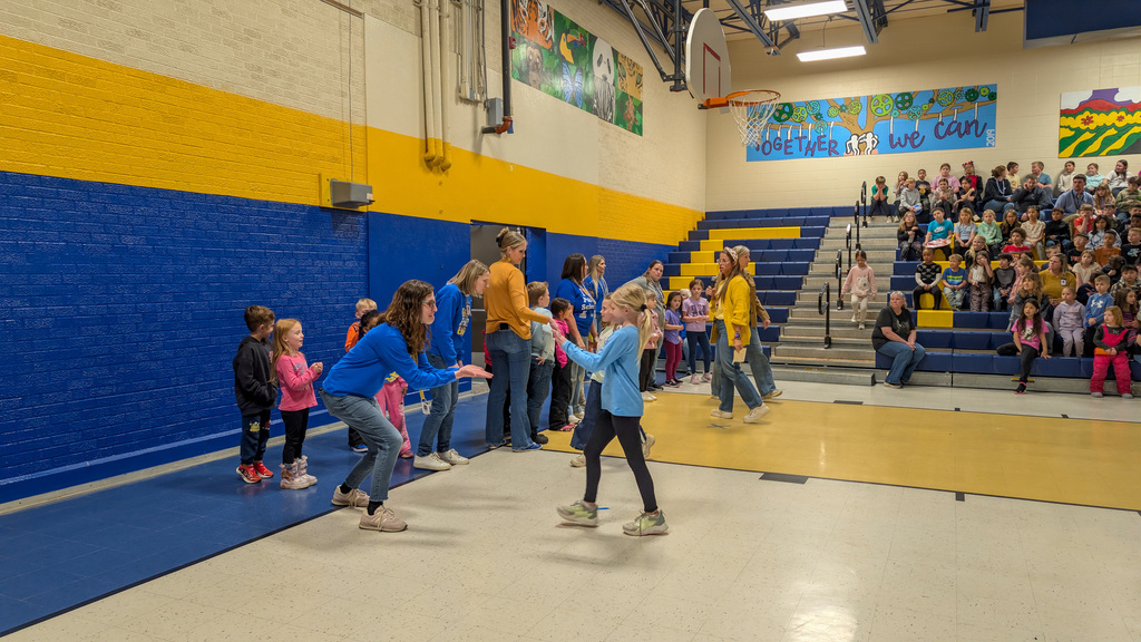 O.M. Tiffany teacher and student high-fiving