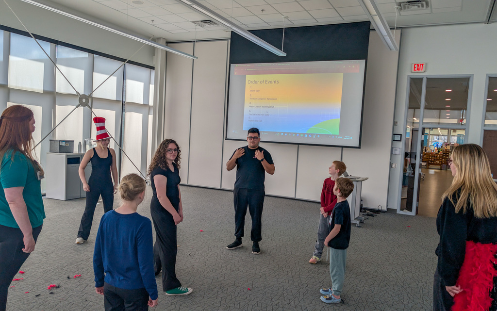 CHS actors helping students at an acting workshop at the library