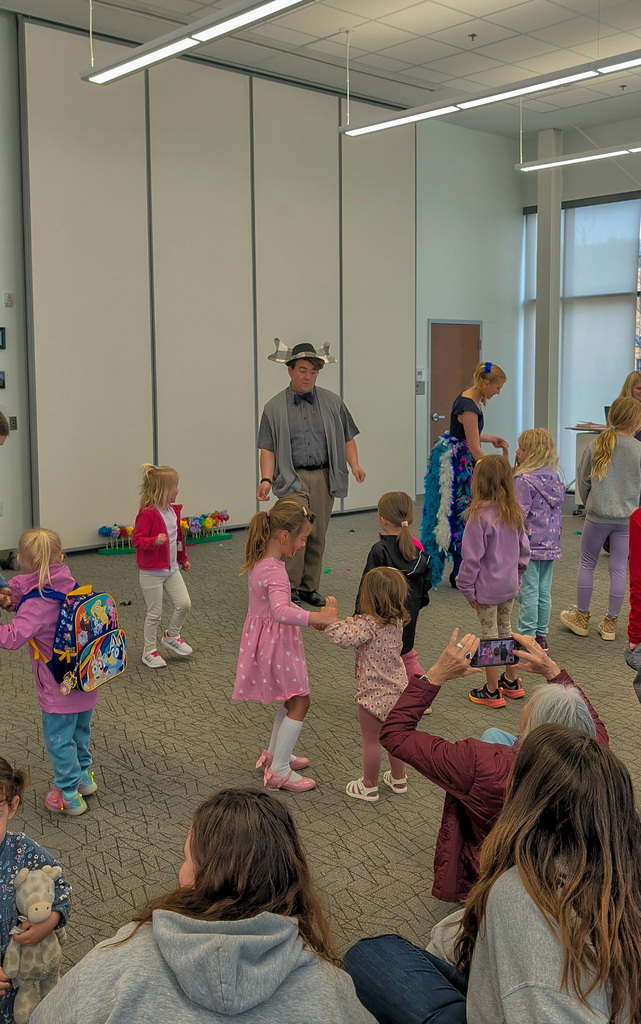 CHS students Joey Johnson and Elsa Schiferl with kids at K.O. Lee Library's Saturday storytime.