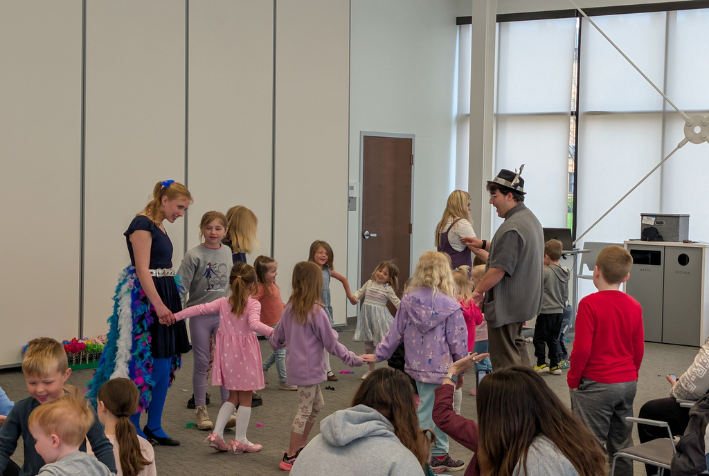CHS students Joey Johnson and Elsa Schiferl with kids at K.O. Lee Library's Saturday storytime.