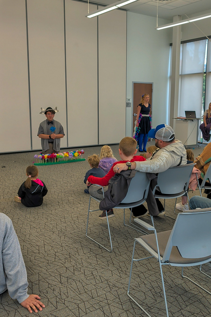 CHS students Joey Johnson and Elsa Schiferl with kids at K.O. Lee Library's Saturday storytime.
