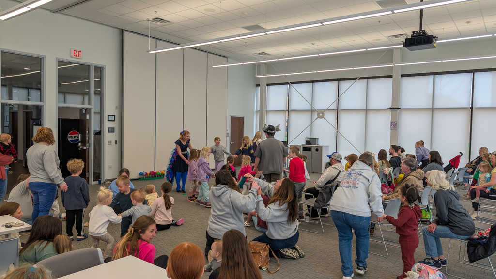 CHS students Joey Johnson and Elsa Schiferl with kids at K.O. Lee Library's Saturday storytime.