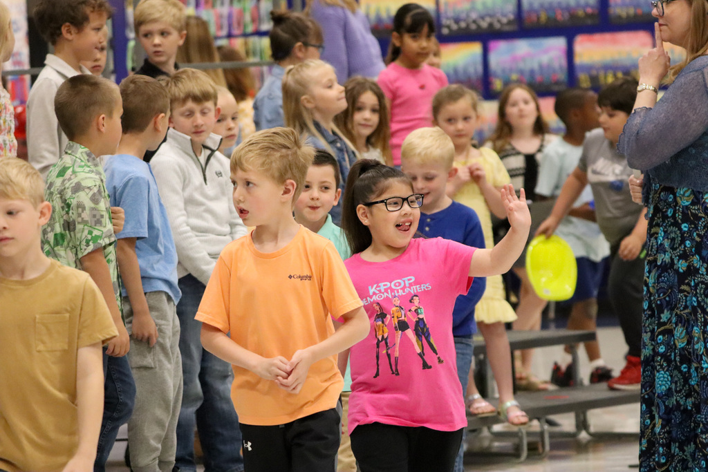 Mike Miller student waving during the spring program