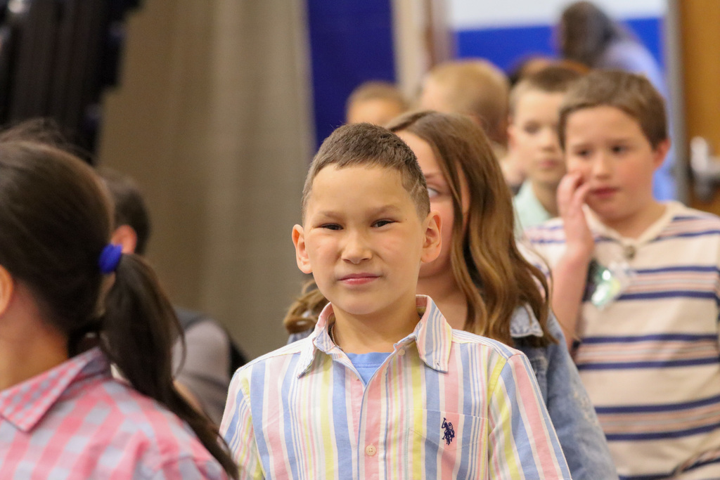 Little boy smiling at the camera at Simmons spring concert