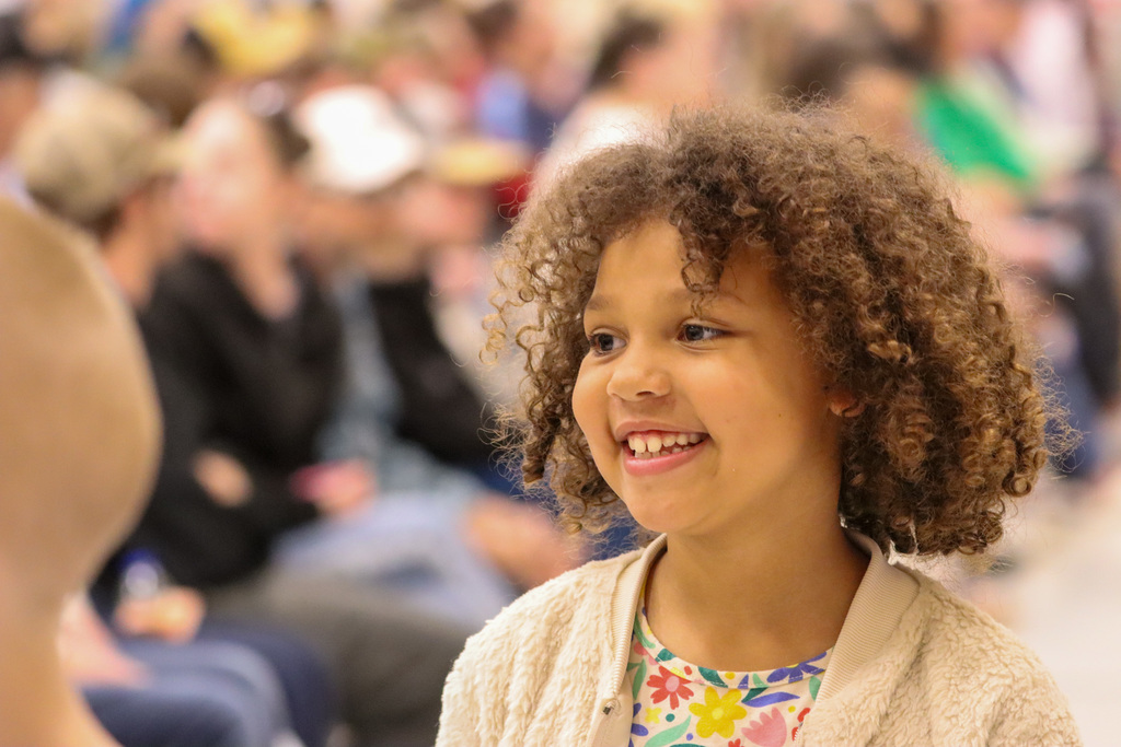 Little girl smiling at a loved one at Simmons spring concert