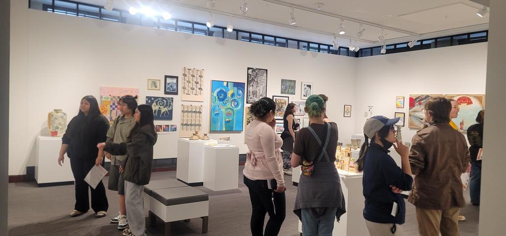 CHS Art Club  members are discussing and critiquing artworks in one of the Washington Pavillion art galleries. 