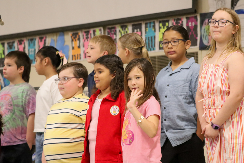 Lincoln student waving to a loved one at the spring program