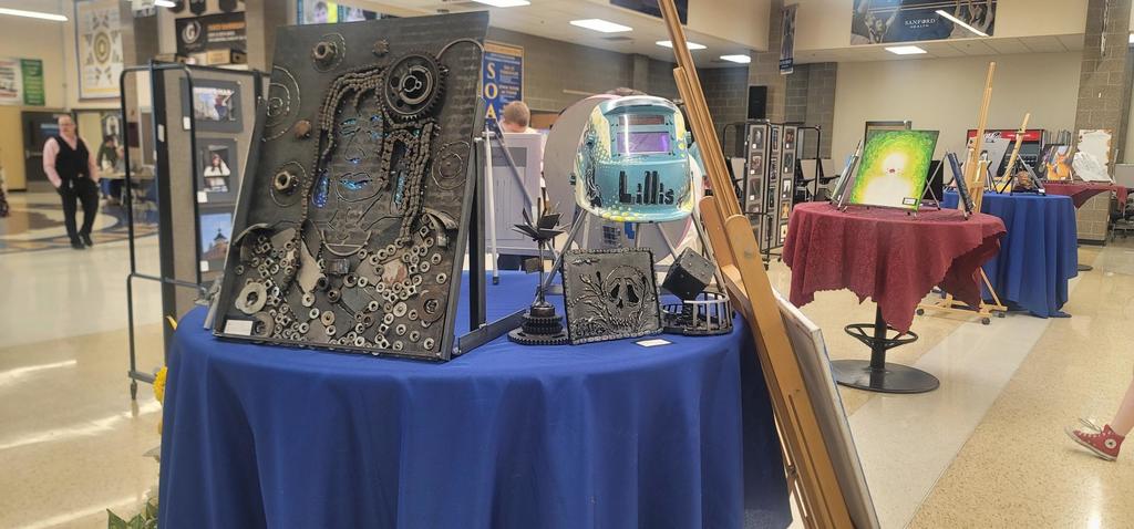 Here, senior Alta Three Legs has her art table with awesome mixed media works, including welding!