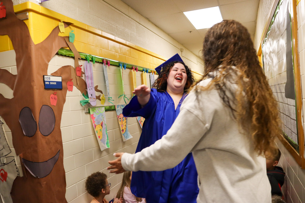CHS graduate hugging a Simmons Elementary teacher