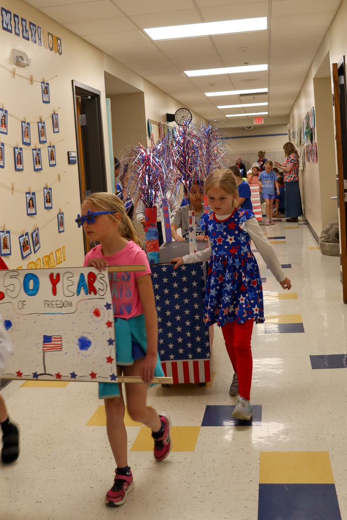 Mike Miller students pushing a patriotic float in their parade
