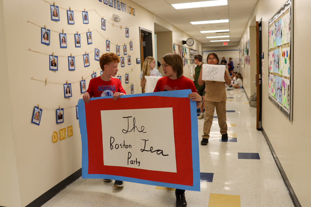 Mike Miller students carrying a Boston Tea Party sign
