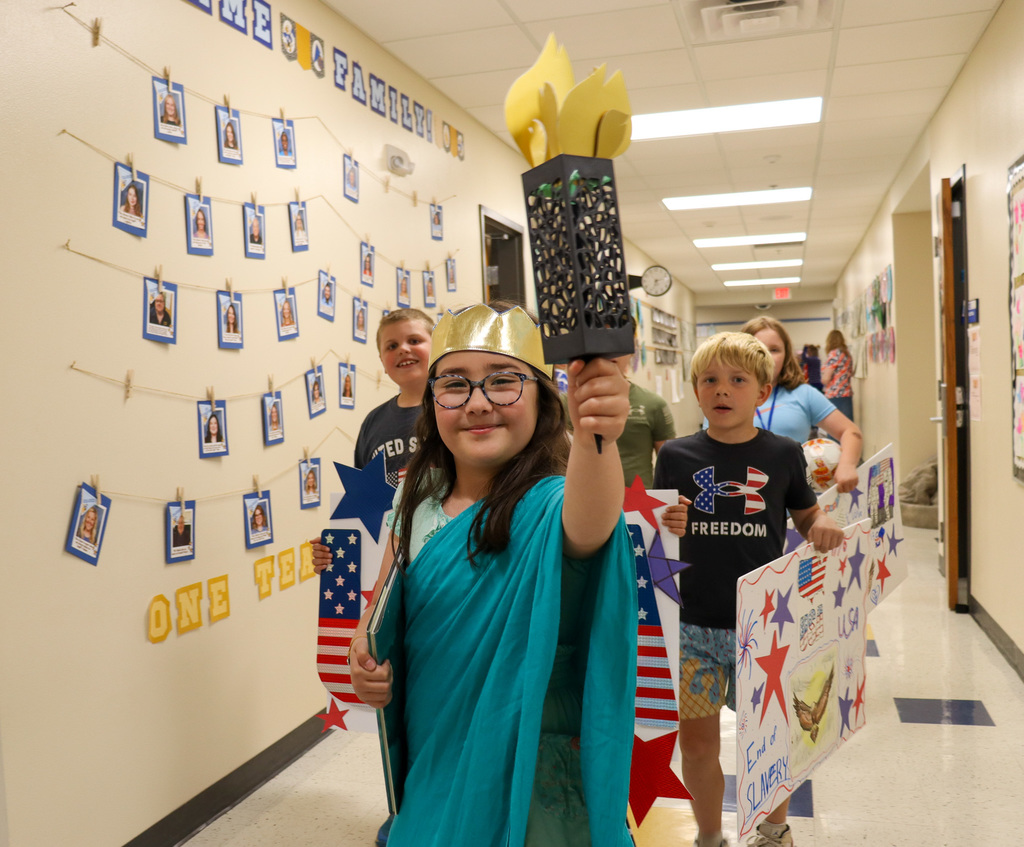 Mike Miller student dressed as Lady Liberty in their parade
