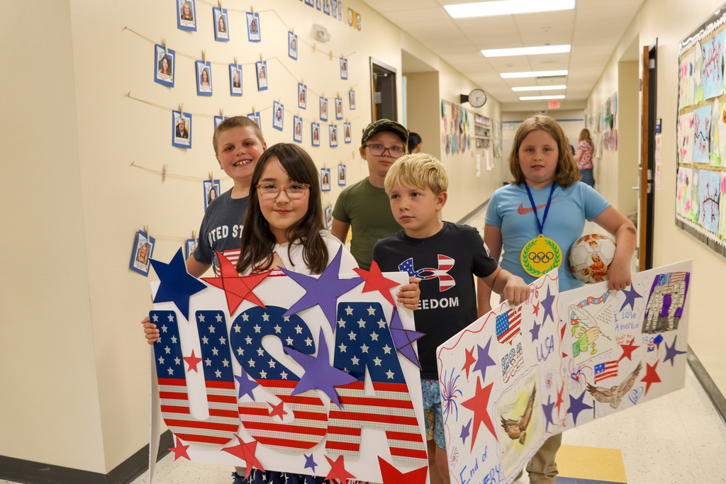 Mike Miller student carrying a USA banner