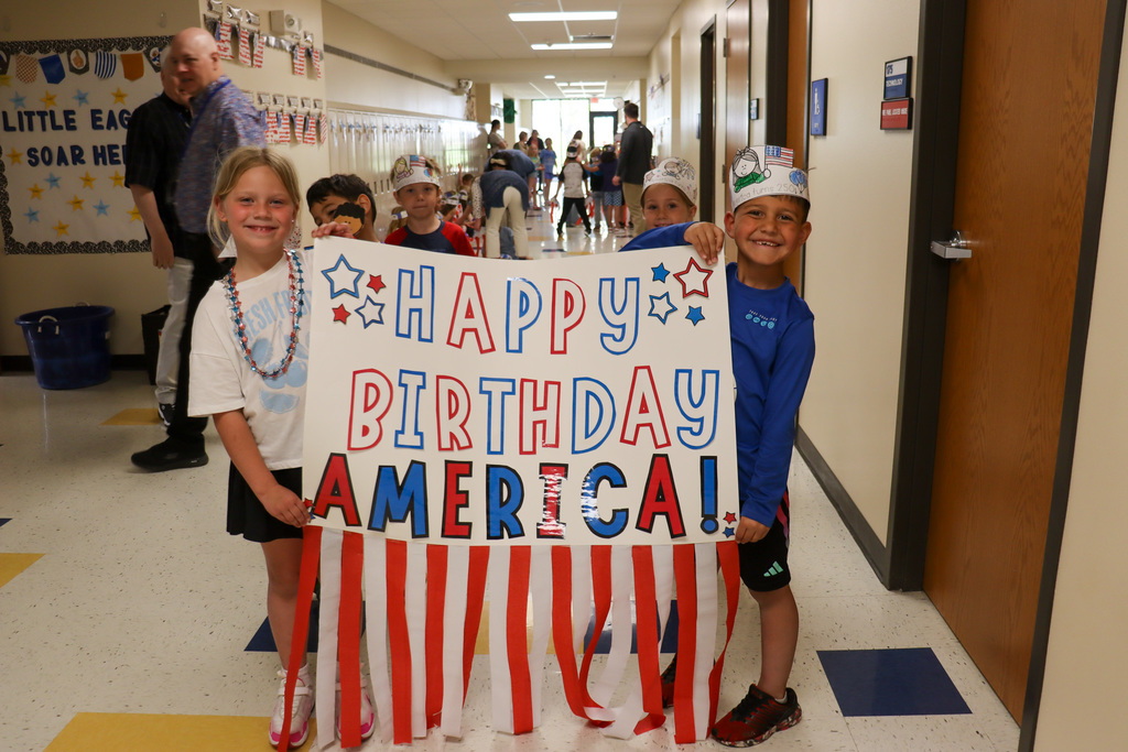 Mike Miller students holding a happy birthday America sign