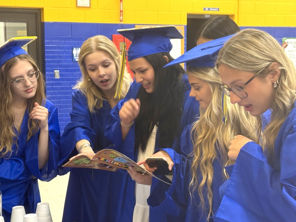 May Overby seniors looking through an old yearbook