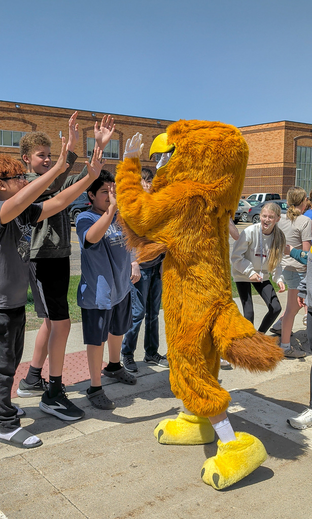 Golden Eagle mascot high-fiving SMS students