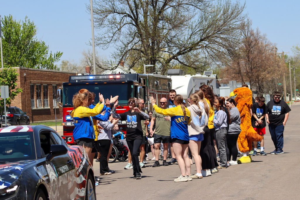 CHS athletes and the Golden Eagle mascot cheer on Special Olympics athletes at the beginning of the Torch Run