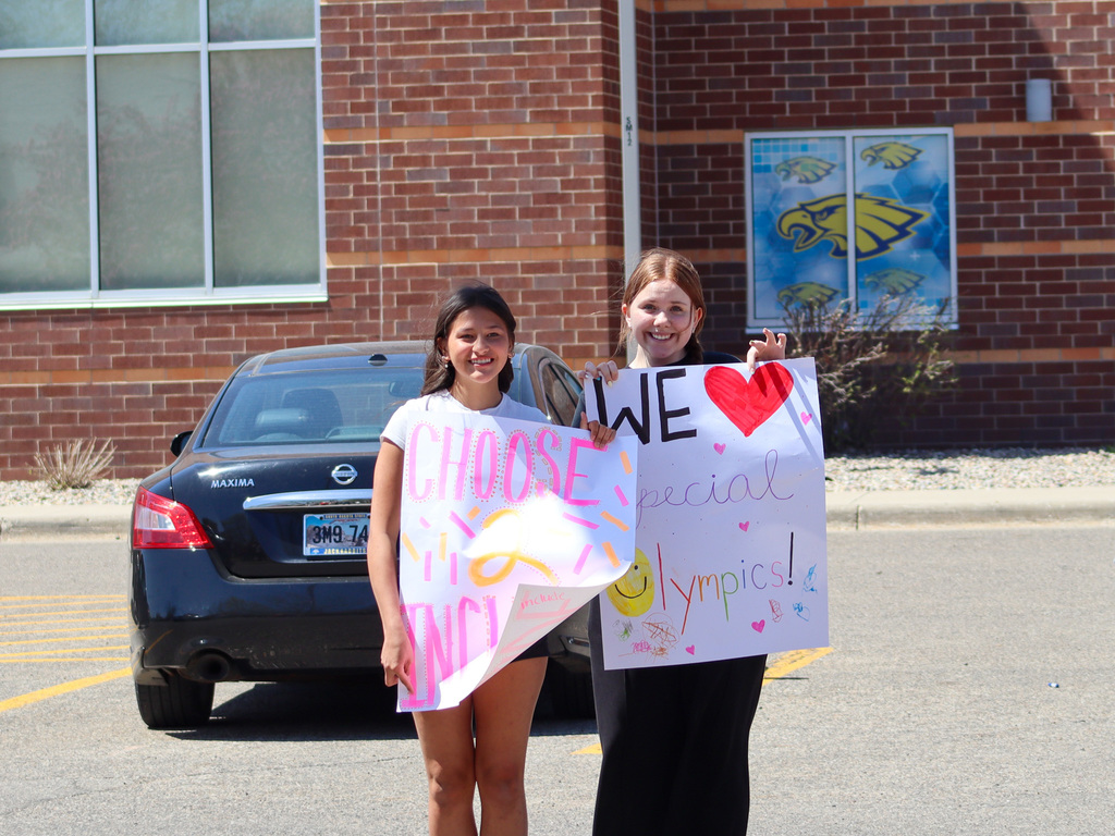 SMS holding up banners saying "Choose to Include" and "We love Special Olympics"