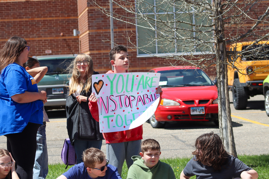SMS student holding a banner that says "You are unstoppable" during the Torch Run