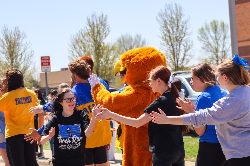 CHS athletes and the Golden Eagle mascot cheer on Special Olympics athletes at the end of the Torch Run