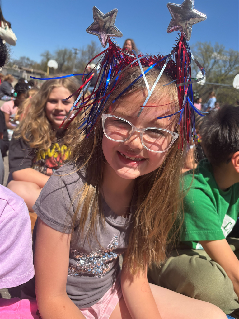 OMT student wearing a head band with stars and red, white and blue streamers at the America 250 Grillout