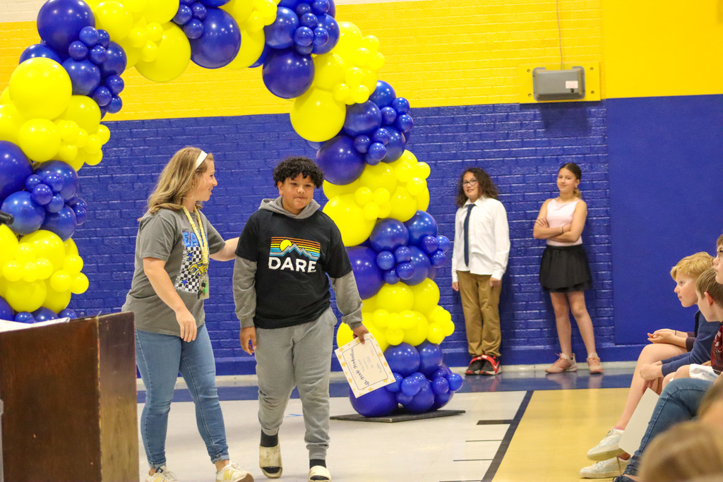 OMT 5th grader getting his certificate from Mrs. Blocker at the graduation ceremony
