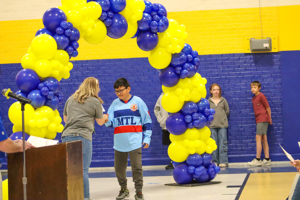 OMT 5th grader getting his certificate from Mrs. Blocker at the graduation ceremony