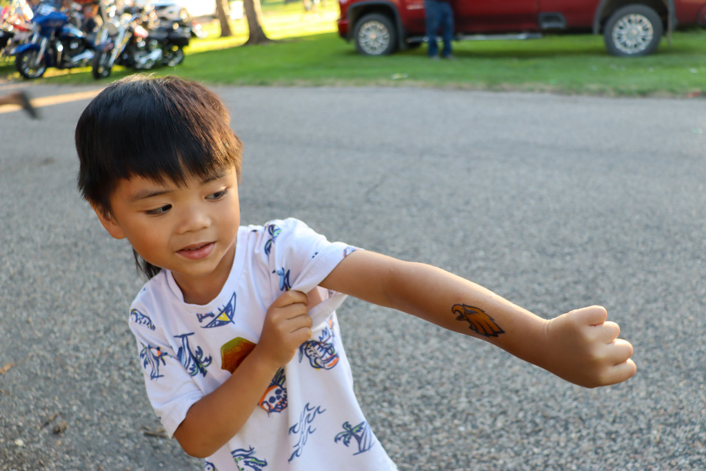 A child showing off a Golden Eagle tattoo at National Night Out