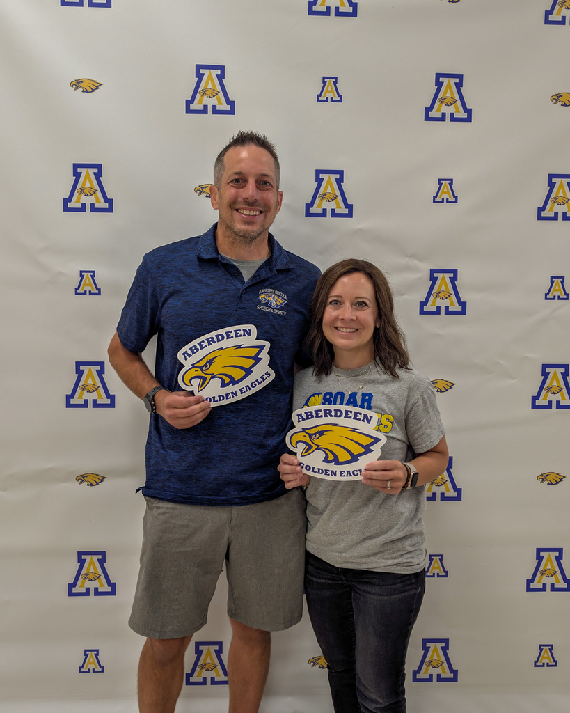 Aberdeen Public Schools teachers smiling and holding Eagles signs